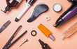 Hair care produts and styling items on orange background