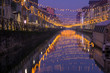 Night view of Naviglio Grande canal waterway in Milan, Italy. Christmas lights are reflected on the water. This district is famous for its restaurants, cafes, pubs and nightlife.