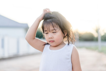 Confused face.little 4 years old girl scratch on head and show confuse face. 