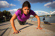 © Novak - Strong fitness urban woman doing push ups