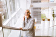© BGStock72 - Senior businesswoman using mobile phone at office