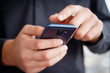 © rahwik - Male hand holding a cell smartphone and writing sms