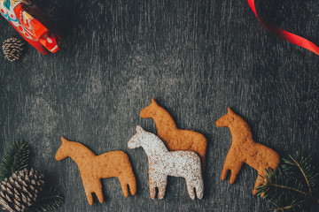 glazed dala horse cookies with red decor and pine cones