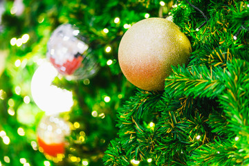 Closeup of Colorful balls on Green Christmas tree background Decoration During Christmas and New Year.