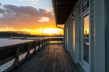 Beautiful lake sunset reflecting in a window of a house