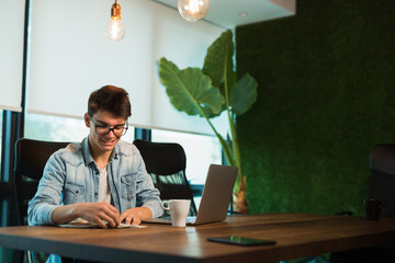 Wall Mural - young designer using pantone color bridge in his office