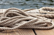 nautical rope close up on a wooden dock at waters edge