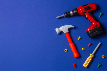 Toys background. Top view of toy tools on blue background