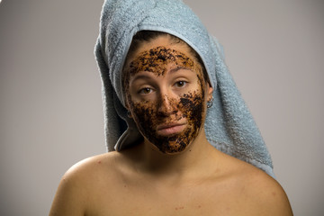 Dubious young woman after shower with two towels