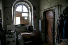 Dark And Shabby Messy Kitchen In Poor  Apartment Of Old Emergency House