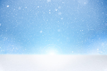 Winter image with white bright and fresh snow at bottom and falling snowflakes on blue background. Background template for your project.