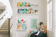 © Crystal Sing  - A little boy reading in a reading corner of his play room.