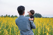 © phoderstock - Father and baby together at sunn hemp field in Chiang Rai, Thailand / Baby finger pointing forward