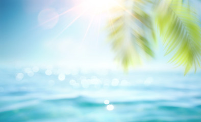 Wall Mural - Abstract blur defocused background, toned gently blue, nature of tropical summer, rays of sun light. Beautiful sun glare on sea water and palm leaves against sky. Copy space, summer vacation concept.