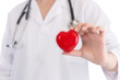 © taskin - Medicine doctor holding red heart shape in hands on hospital background, medical concept