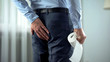 © motortion - Office worker with toilet paper in hand suffering from hemorrhoid pain, diarrhea