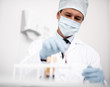 © Yakobchuk Olena - Calm doctor in medical uniform sitting alone and taking test tubes from the table