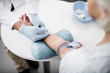 © Yakobchuk Olena - Doctor in rubber gloves conducting vacuum blood collection procedure while standing in front of his patient