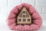 Fototapeta  - new home with a cozy knitted scarf on a light background with copy space, a gift for Valentine's Day, the idea of a family of love and comfort