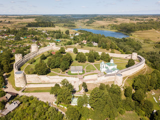 Wall Mural - Izborsk medieval Russian fortress (kremlin) with a church. Aerial drone photo. Near Pskov, Russia. Birds eye view