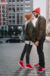 © Yakobchuk Olena - Full length side view portrait of handsome bearded man and his charming girlfriend spending time outdoors. They looking at each other and smiling