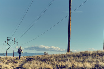 Man walking under Powerlines