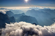 © nogreenabove2k - View from Triglav summit with blue ridges of Julian Alps, hazy Trenta valley of Soca river and low white clouds under glowing horizon in autumn sunshine, Triglav National Park Slovenia / Italy Europe