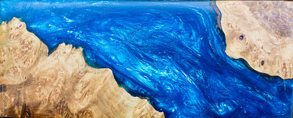 casting epoxy resin Stabilizing burl wood blue abstract background, Texture of a wooden resin