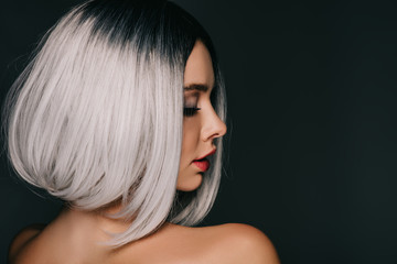 attractive glamor girl posing in grey wig, isolated on black