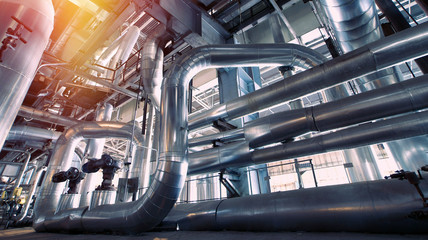 Equipment, cables and piping as found inside of a modern industrial power plant