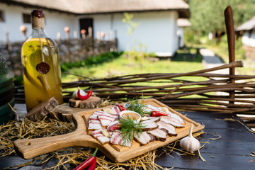 Wall Mural - Ukrainian bacon on a wooden board with sauce and dill