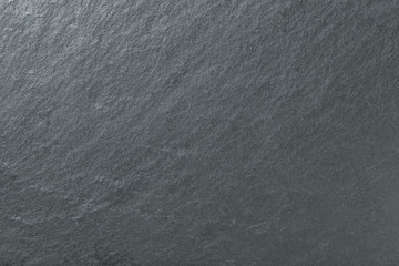 Wall Mural - dark gray background of natural slate. texture black stone closeup.