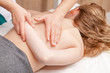 Tween girl receiving osteopathic treatment  or medical massage of her arm and shoulder blade
