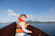 © Connect Images - Boy looking back from front of rowing boat, Aure, More og Romsdal, Norway
