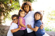 © Westend61 - Portrait of smiling mature woman with three children