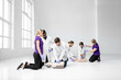 © rh2010 - Group of young medics practising to make artificial breathing with medical dummies during the first aid training in the white room
