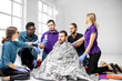 © rh2010 - People during the first aid training with instructors and man as injured person covered in thermal blanket indoors
