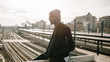 © Angel Ruiz Sanchez - Side view of young african man sitting station train background