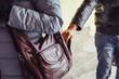 © DedMityay - Thief steals phone or smartphone from bag of  woman close up, pickpocket in city