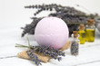 Natural cosmetics. Handmade lavender bath bombs and lavender flowers on white wooden planks