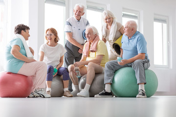 Sticker - Low angle on happy elderly people on balls after gymnastic classes in the studio