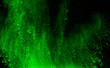 abstract green powder splatted background,Freeze motion of color powder exploding/throwing color powder,color glitter texture on black background