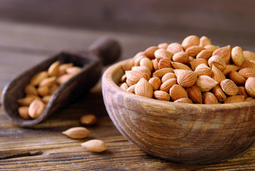 Wall Mural - Dry apricot seeds in a wooden bowl.