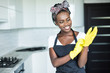 © F8  \ Suport Ukraine - Young beautiful african woman wear rubber gloves preparing for cleaning at homw
