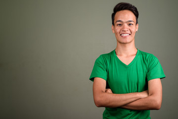 Wall Mural - Young handsome Indian man against colored background 