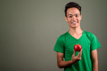 Wall Mural - Young handsome Indian man against colored background 