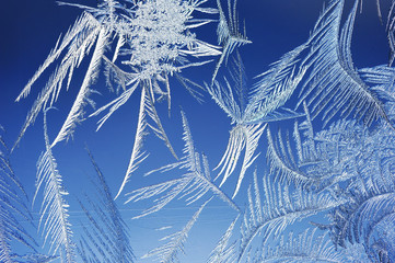 Winter background, frost and ice crystals on window.