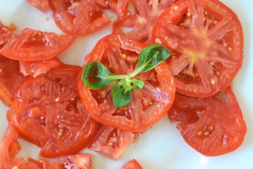 Wall Mural - Vitamin salad of fresh vegetables on a round plate on an old table. Vegetarian dish. Selective focus.