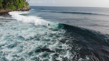 Drone Elevating Above Waves And Surfers In A Beach Cove Called Wong Tong. Most Consistant Reef Break In The Area On The Remote Island Of Simeulue, Off The Coast Of North Sumatra In Indonesia.