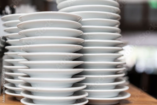 Fotografia, Obraz Pile of white plates in restaurant, close up